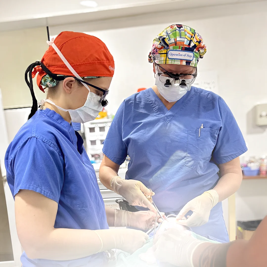 Two otolaryngology surgeons perform an operation