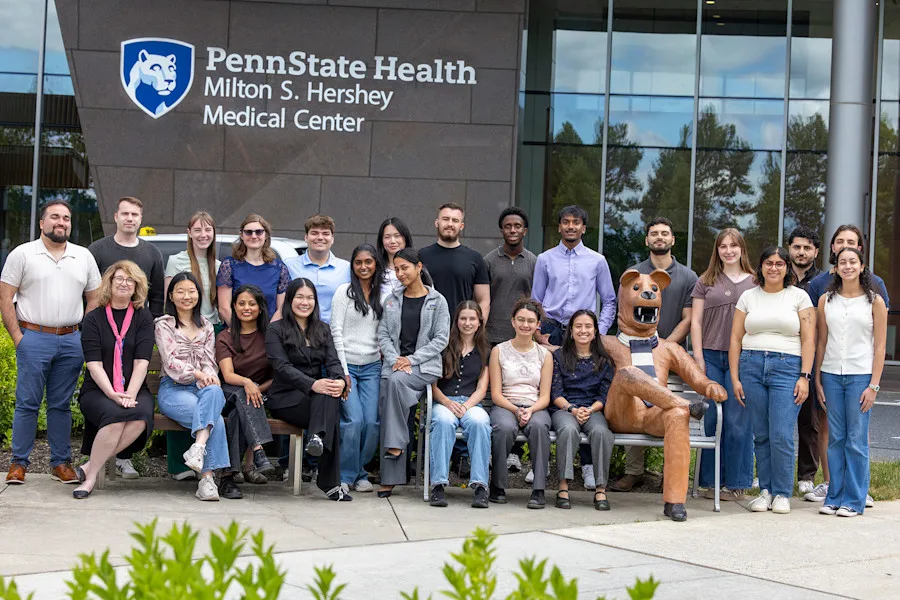 2026 program participants standing around the Nittany Lion statue in front of the medical center