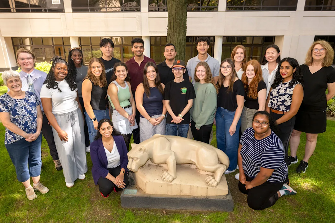 2025 program participants standing around the Nittany Lion statue outside in the college courtyard