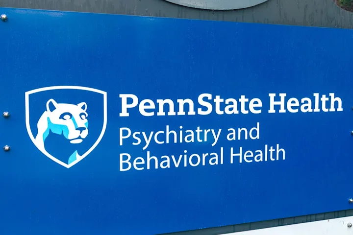Close-up of a sign that with Penn State shield mark and Penn State Health Psychiatry and Behavioral Health