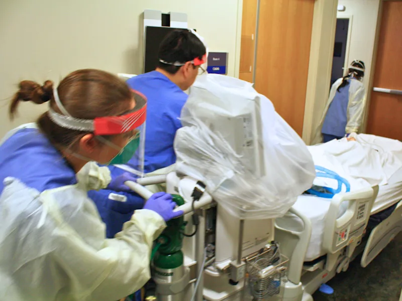 Clinicians in PPE simulate patient transport during anesthesia training at the Clinical Simulation Center.