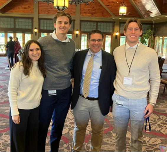 Four people stand together for a photo during an event at Hershey Country Club
