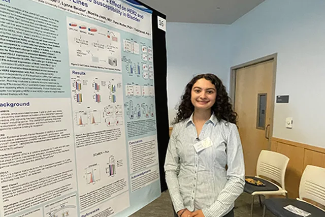 A program participant presents her research poster at the Poster Symposium