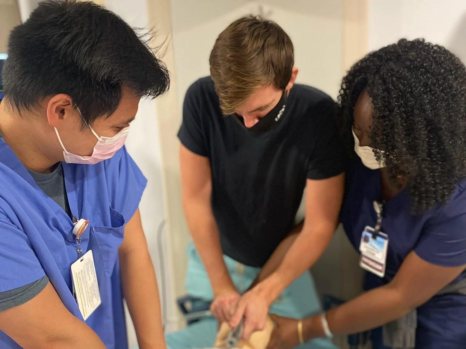 Three residents work on a simulation