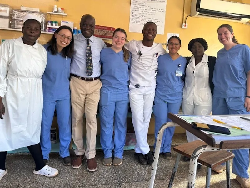 8 people - hospital staff, a Global Health site leader, and students including scholarship winner Sundip Singh in Zambia.