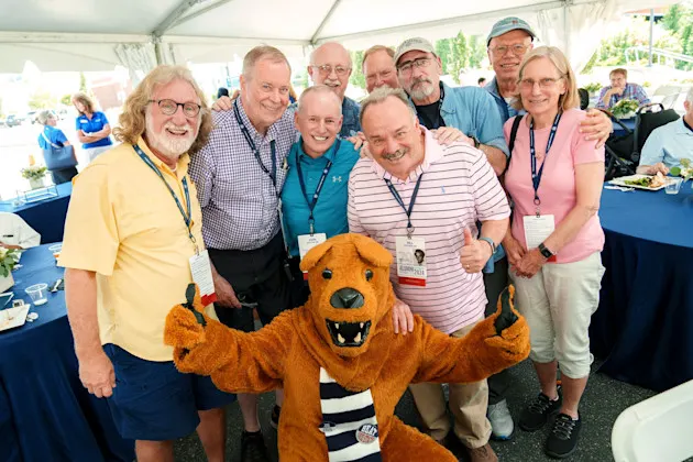 A group of people posing with the Nittany Lion mascot