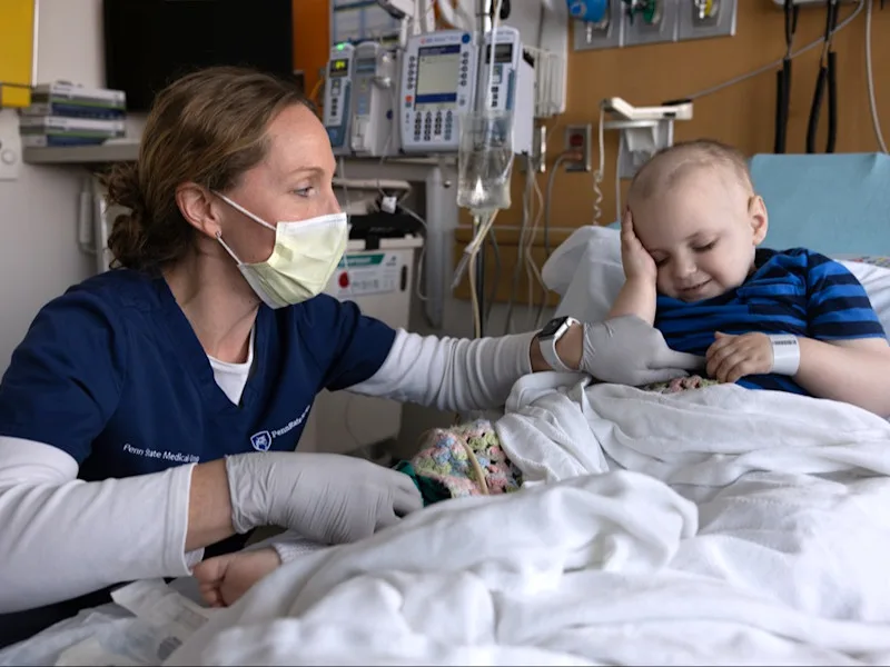 A nurse prepares a young patient for blood work at Penn State Health Golisano Children's Hospital