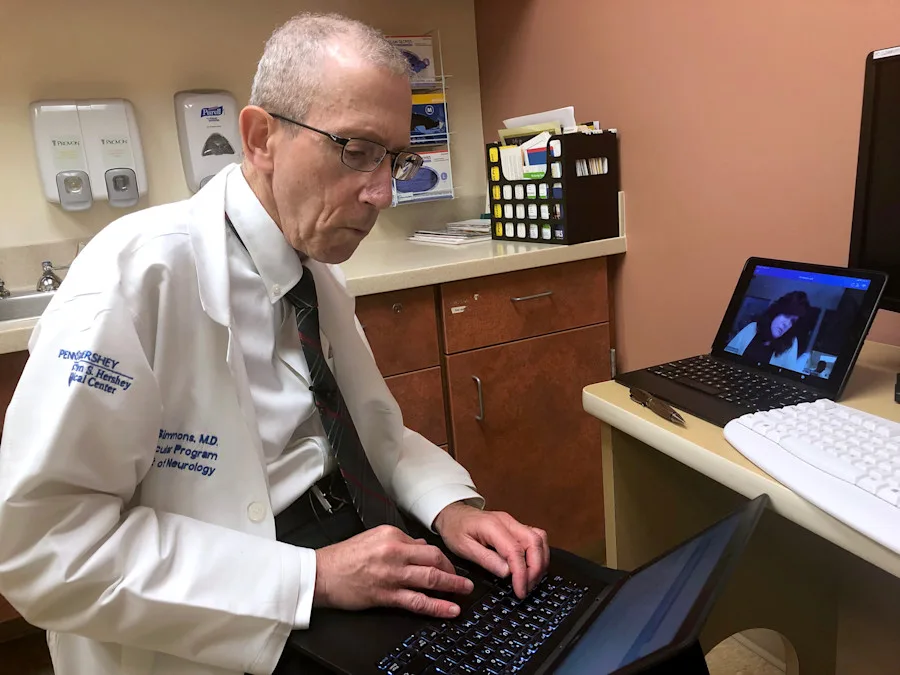 Dr. Simmons works on a computer in a screening room