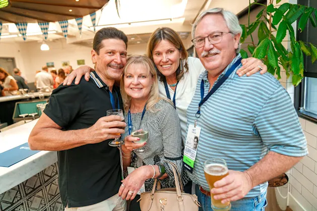 Four people posing at a restaurant.