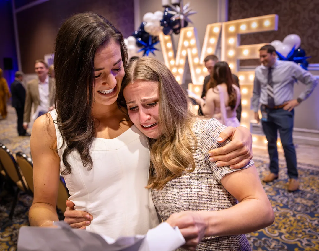 Medical students embrace after finding out their residency matches.