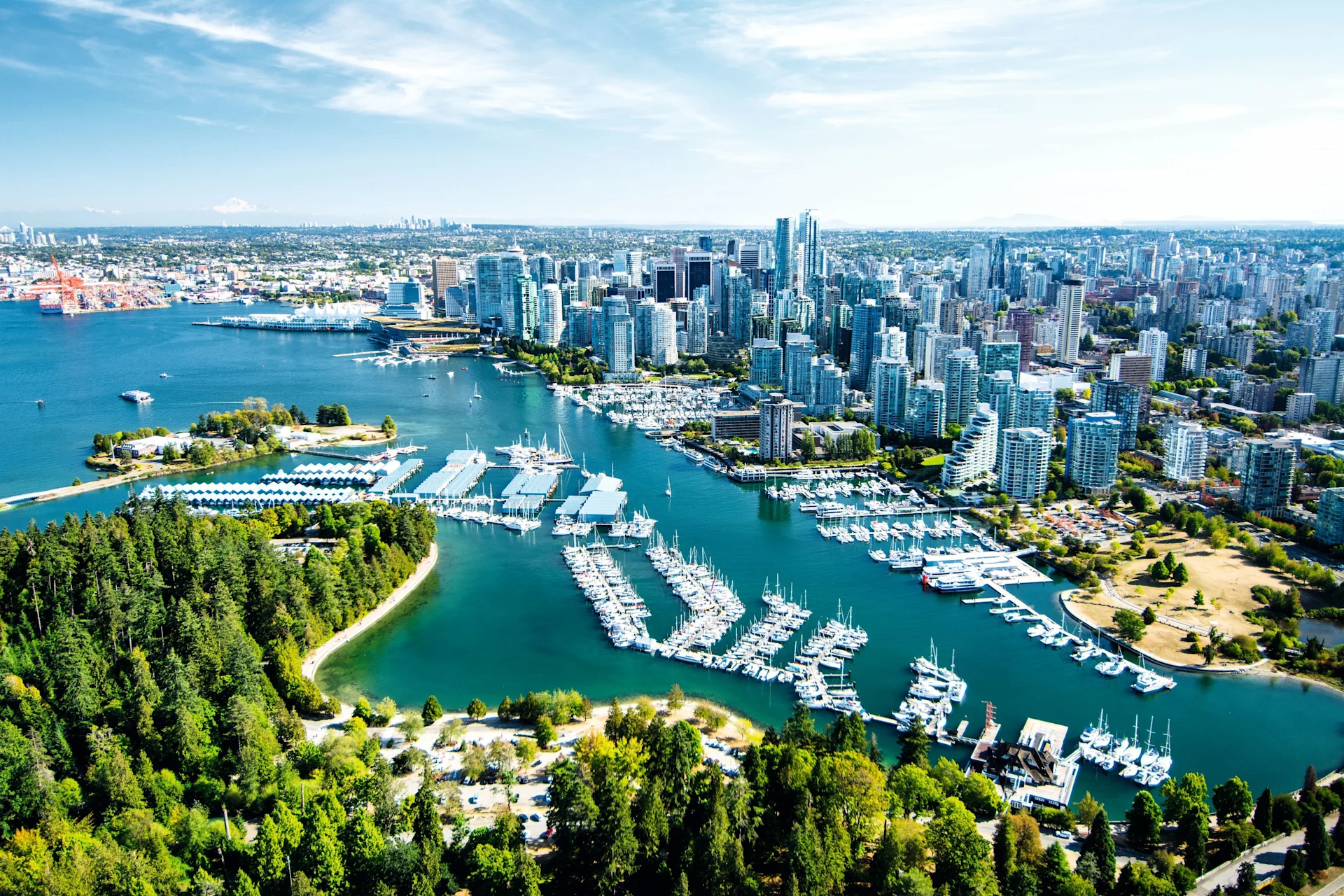 Aerial view of Vancouver skyline, marina, and waterfront beside Stanley Park on a clear day