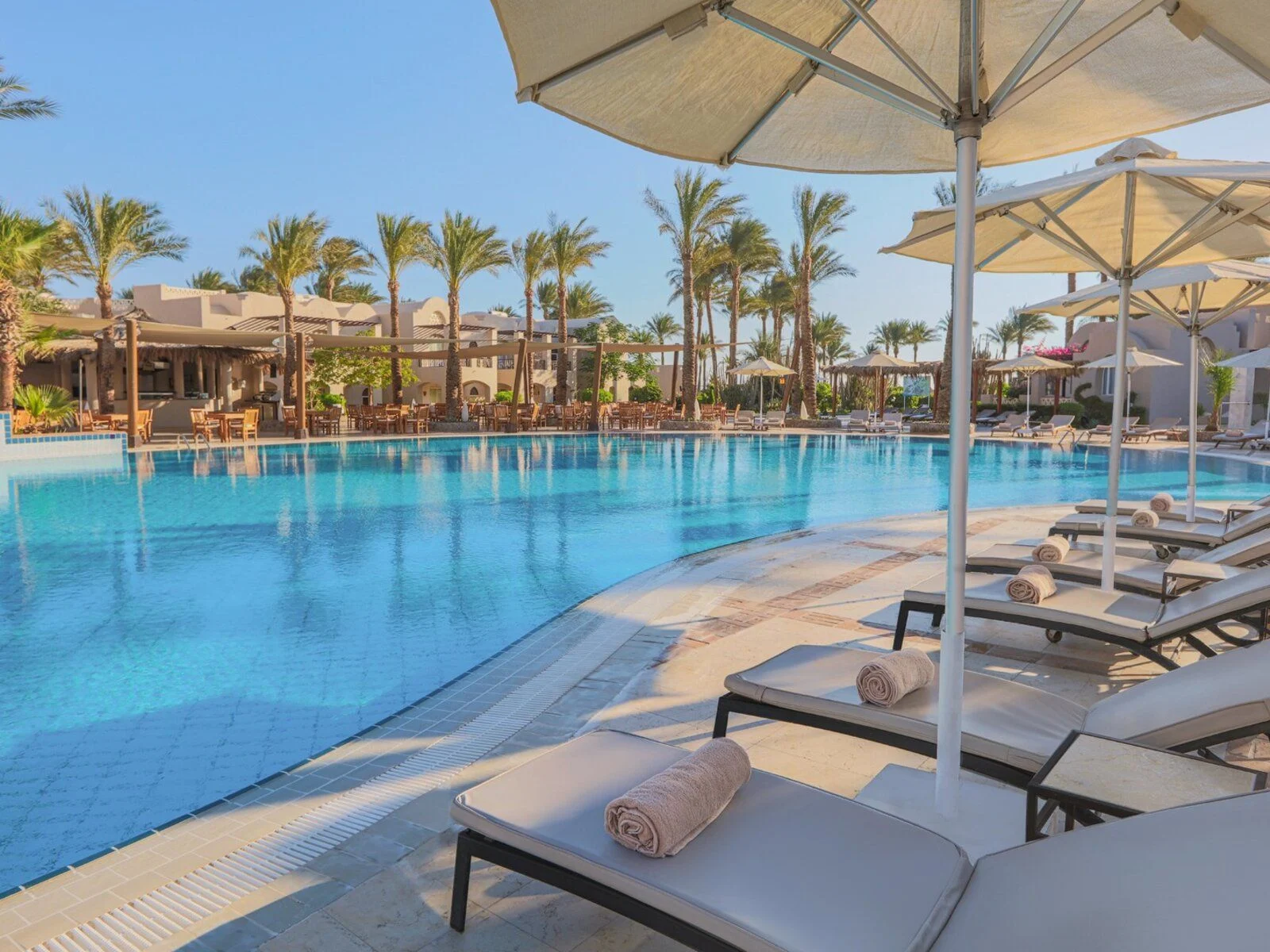 Sun loungers and umbrellas at the pool of Iberotel Makadi Beach