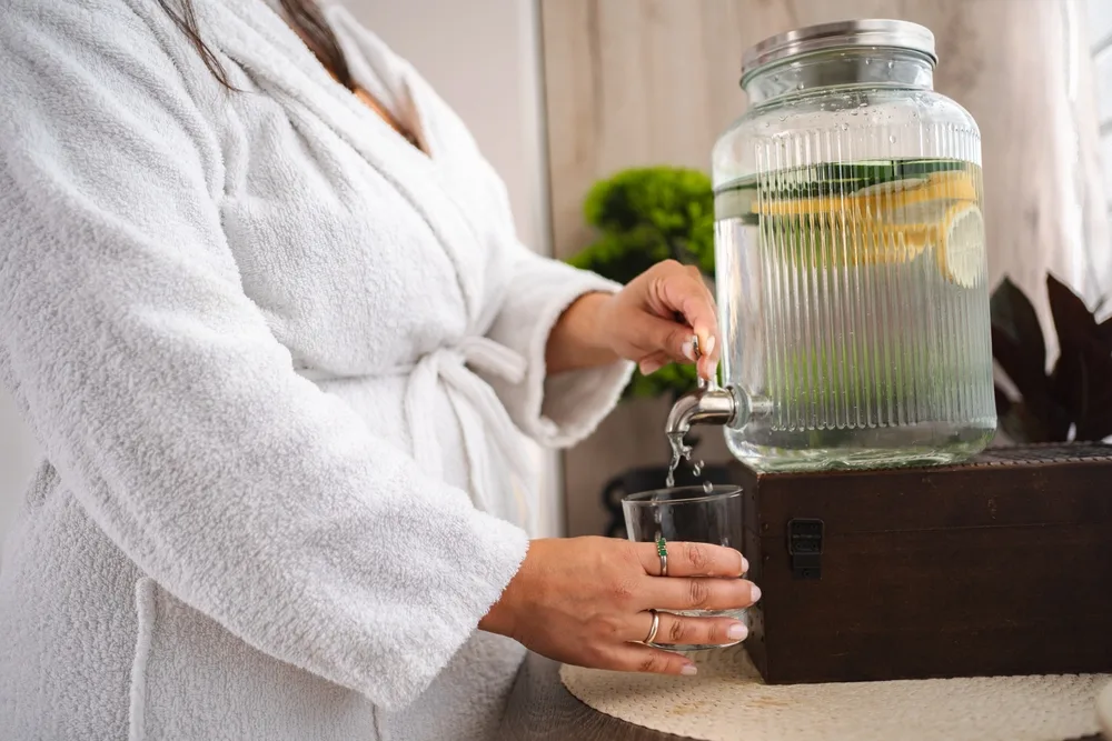 woman-pouring-infused-water-into-glass