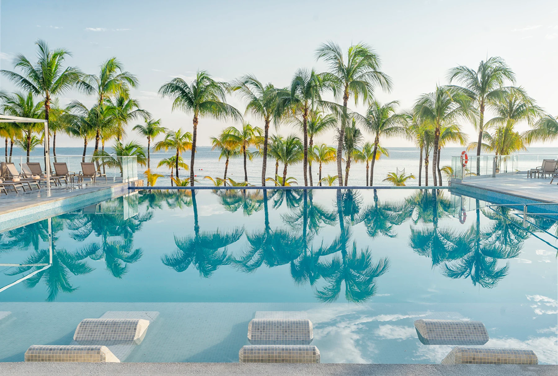 Pool and palm trees at Hotel Riu Caribe
