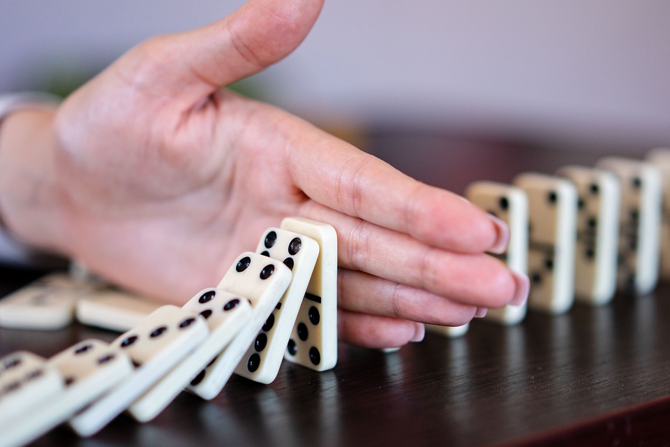 dominoes-stopped-by-hand