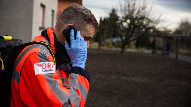 Das Bild zeigt den Notfallsanitäter Thomas Scheffler mit seinem Diensttelefon am Ohr.