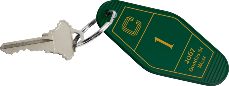 A silver key tchotchke with a green plastic hotel room tag.