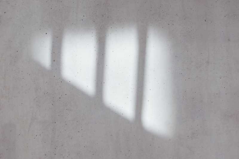 Light coming through a window and landing on a wall. Created by Bernard Hermant on Unsplash.