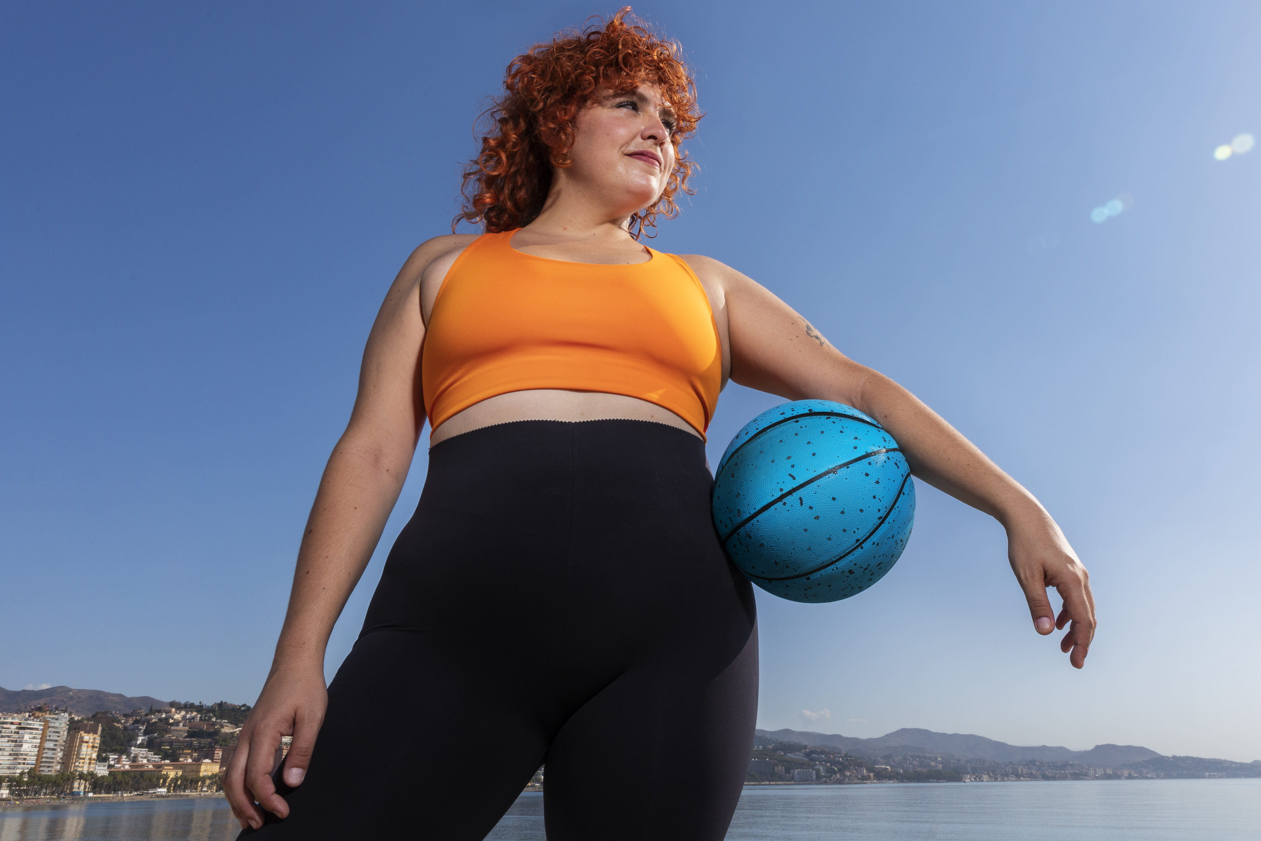 low-angle-woman-holding-ball