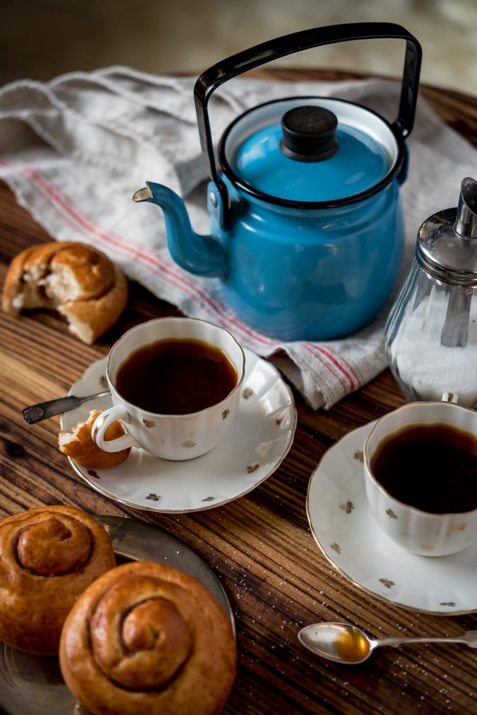 Enamel coffee pot and two cups of coffee