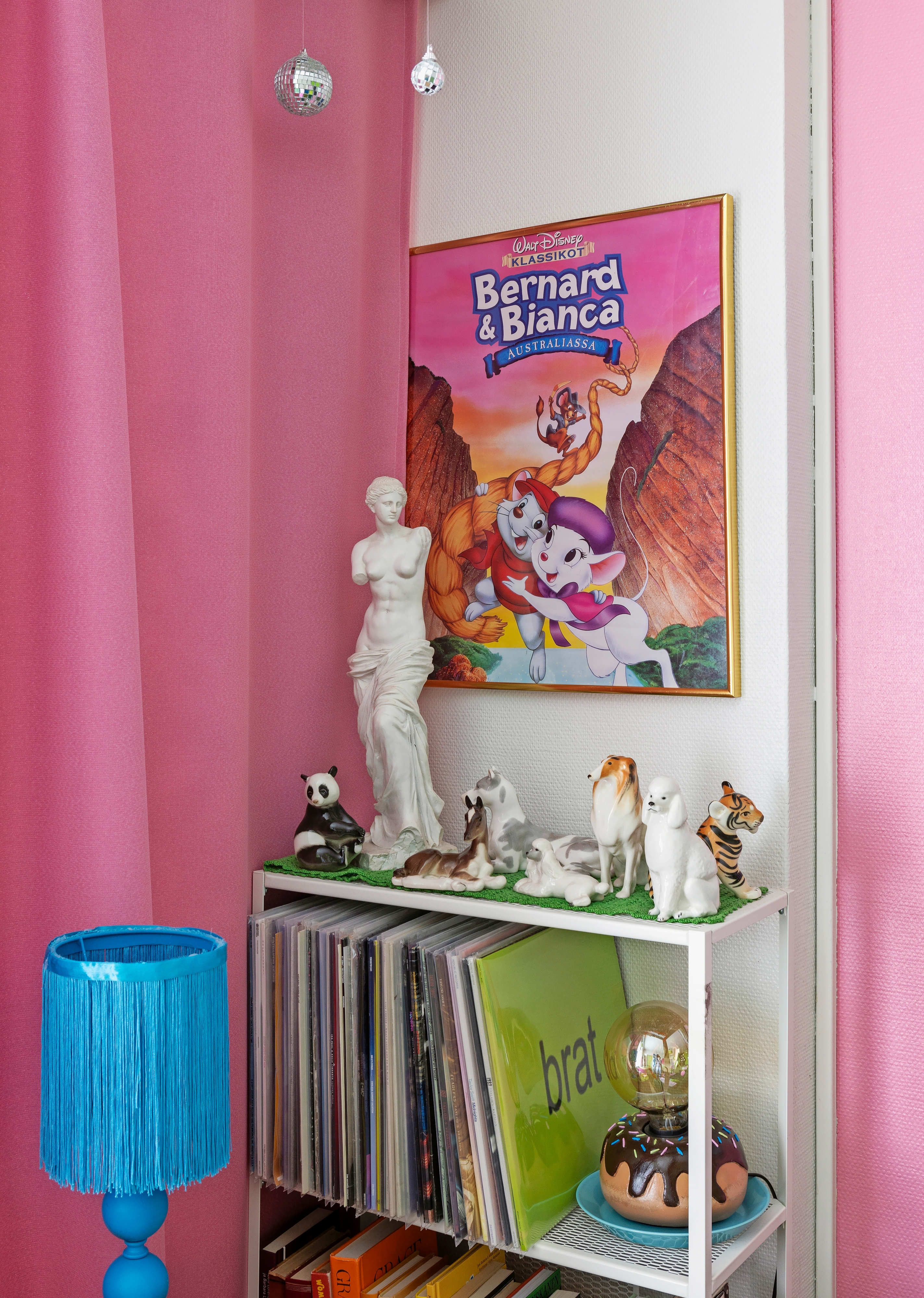 Porcelain animals and vinyl records on a shelf.
