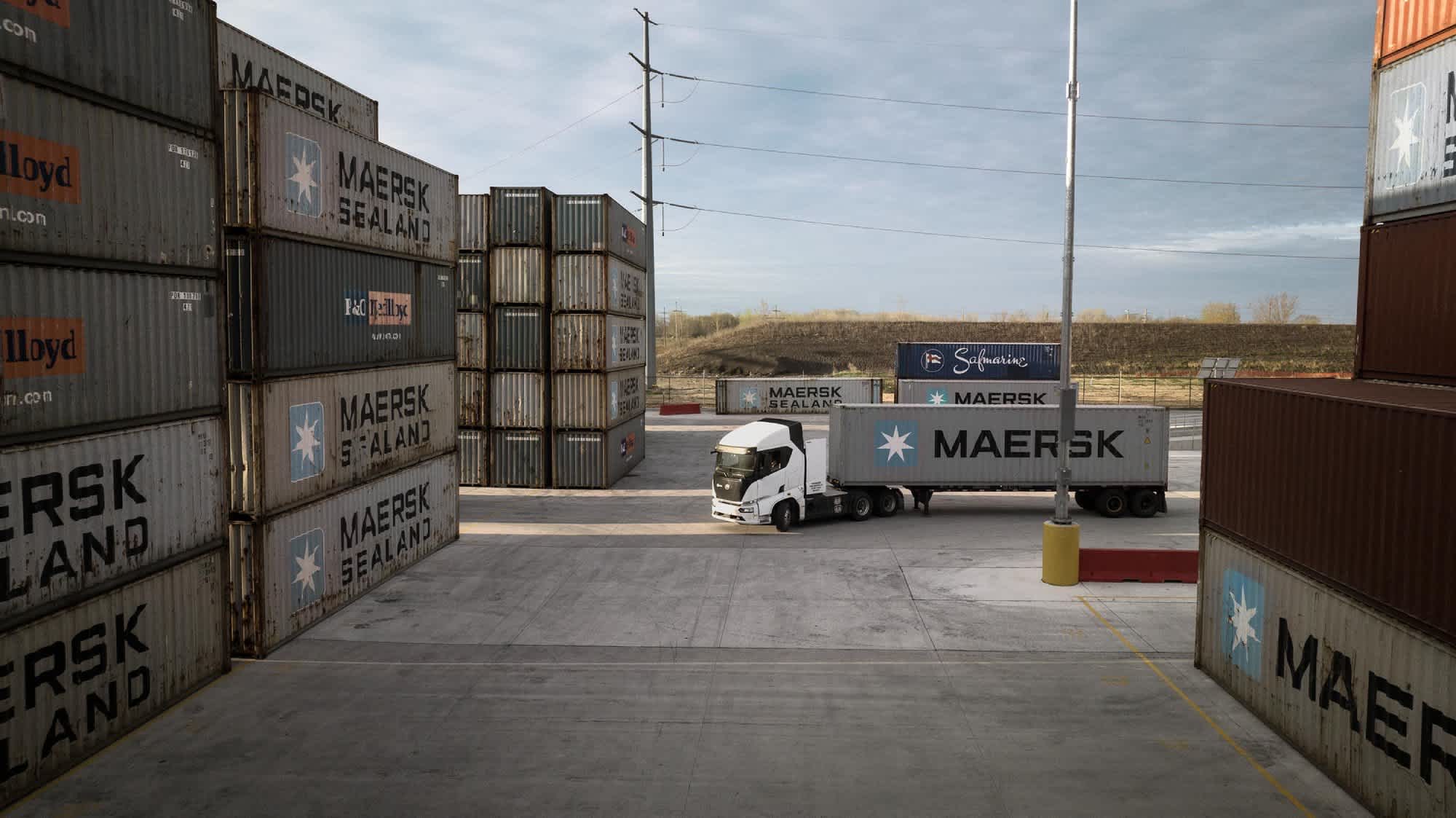 A view from overhead of a Maersk truck in a truck lot among pallates.