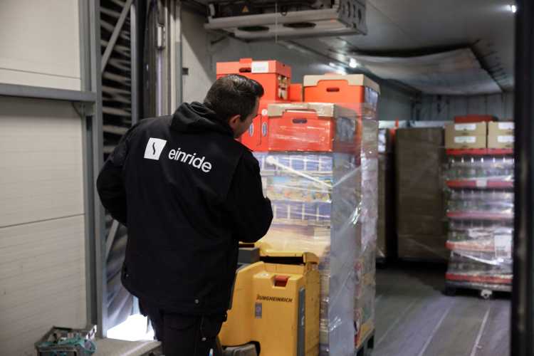 An Einride driver loading a pallet into the back of an Einride truck