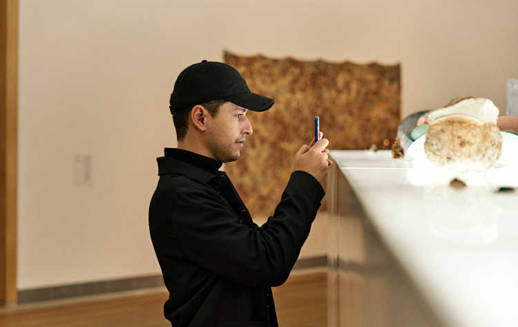 Rui Eduardo, Einride designer, takes a picture with his phone.