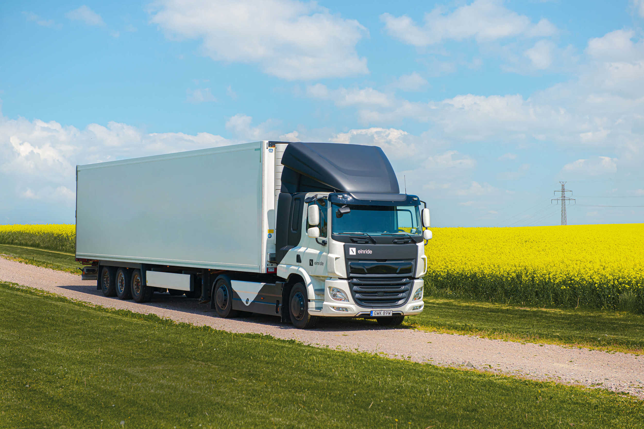 Einride truck driving through a field of raps