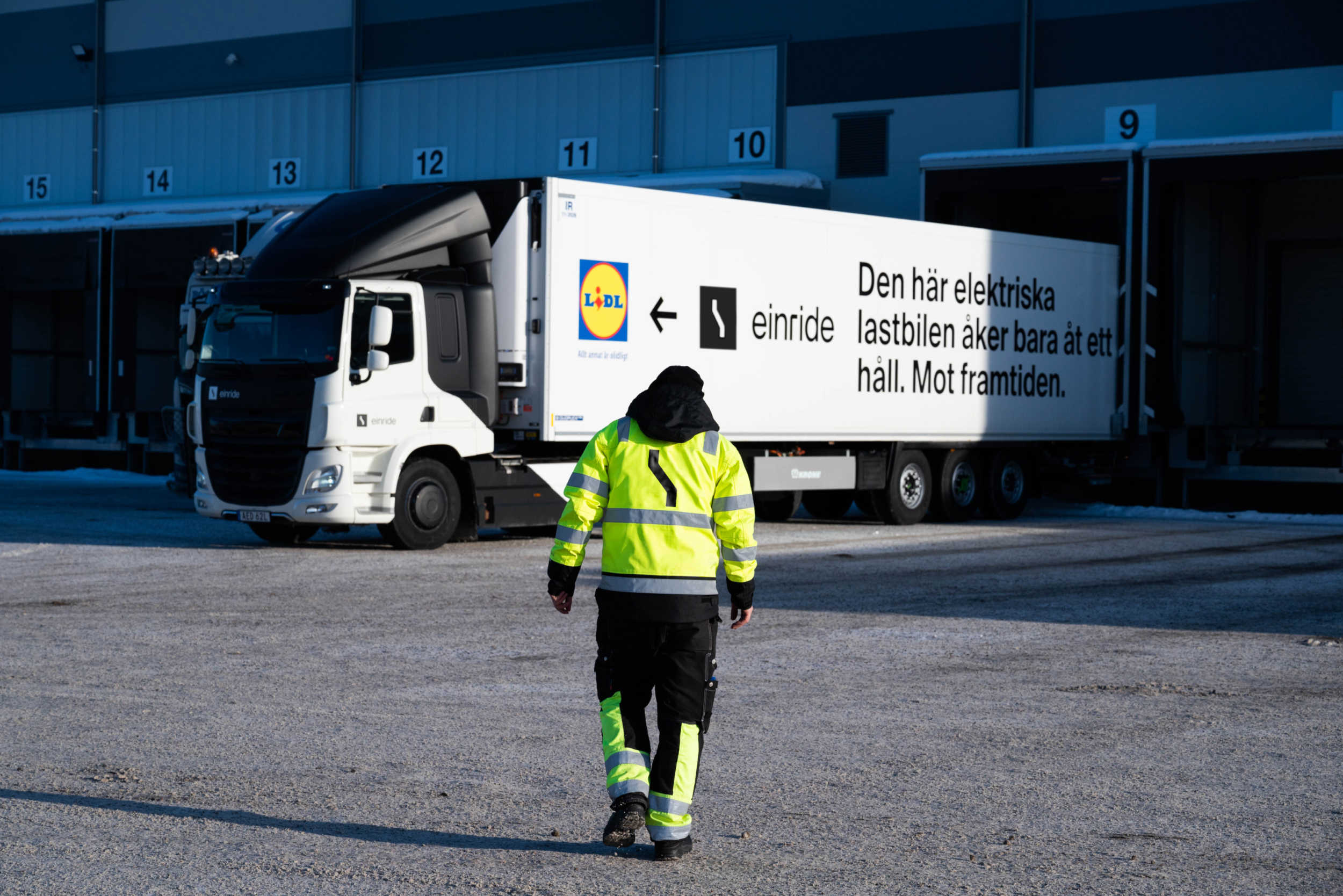 Truck driver walking towards an Einride Truck at the Lidl warehouse