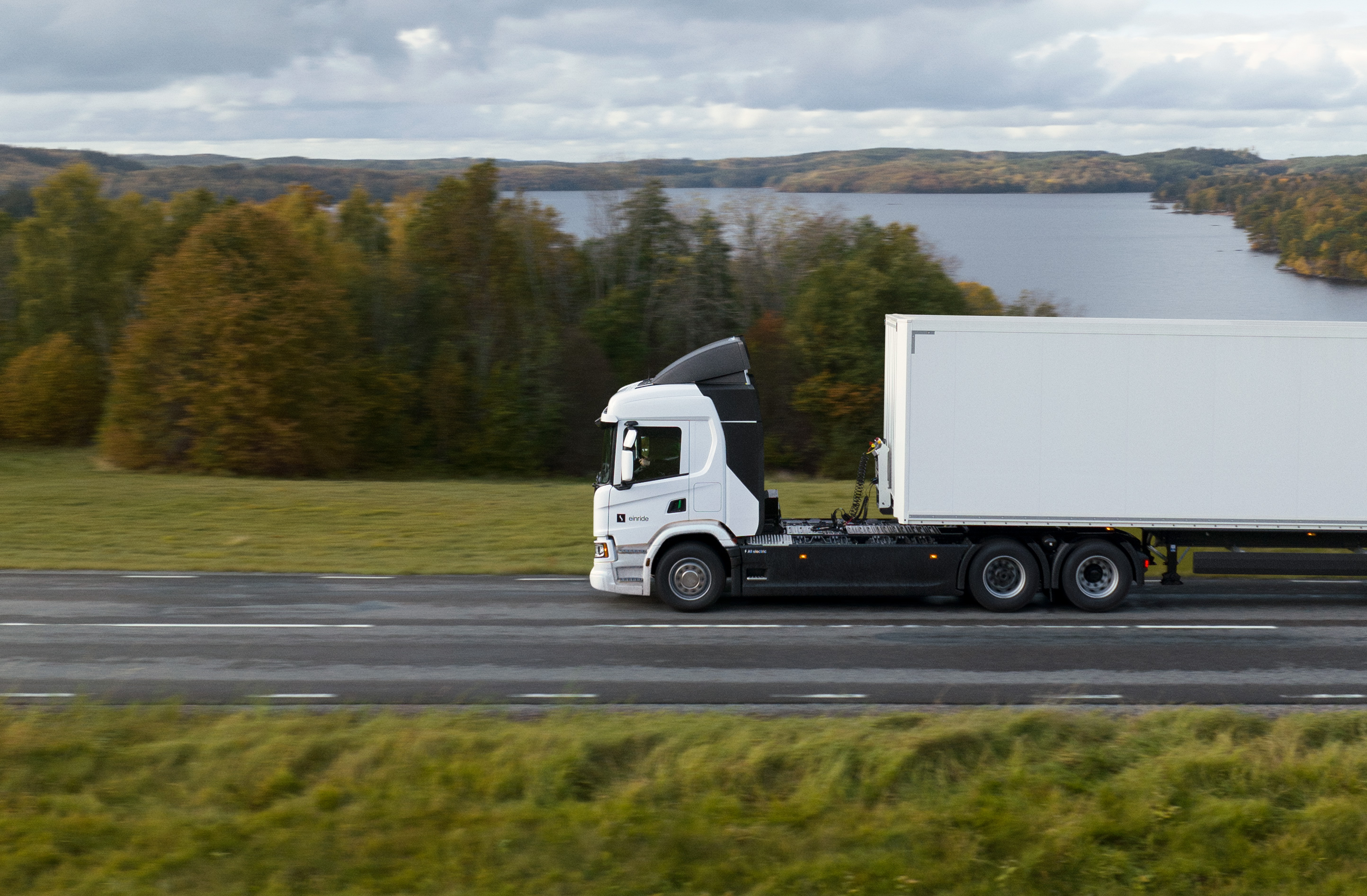 Einride truck driving by a lake