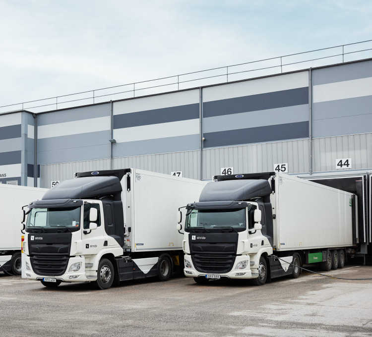 Two Einride electric trucks parked at a loading dock