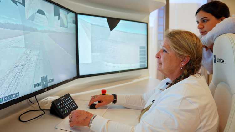 Remote operator Tiffany Heathcott sits in front of her screens and control elements.