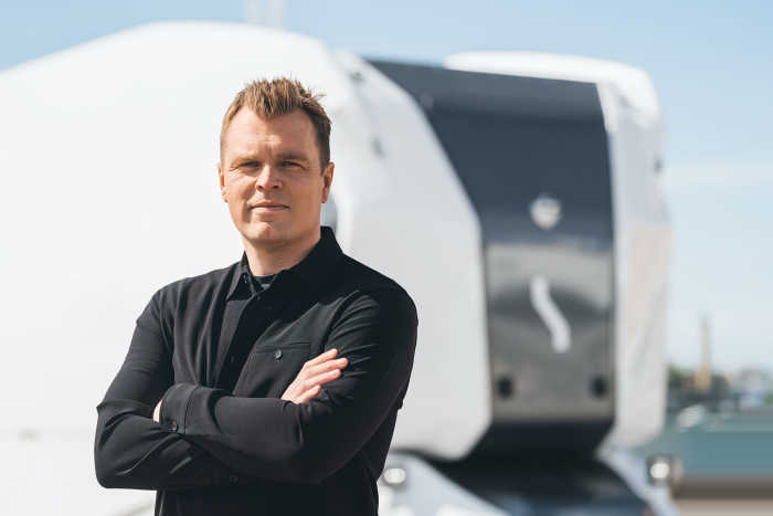 Portrait of Robert Falck, Einride's CEO and Founder, in front of the company's autonomous vehicle