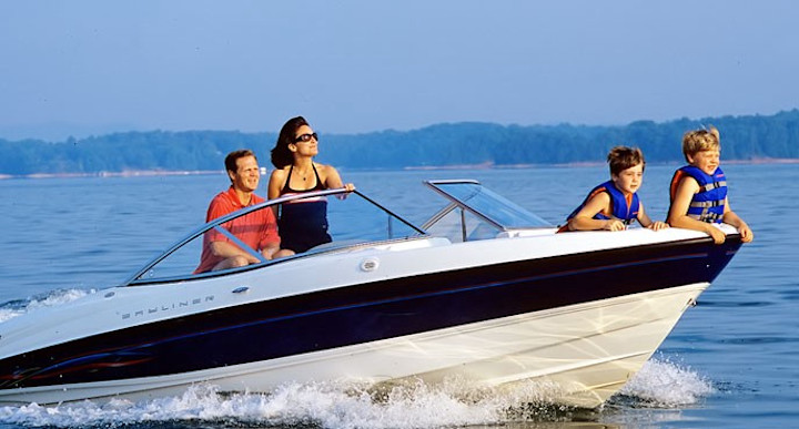 A family rides on a boat on a lake.