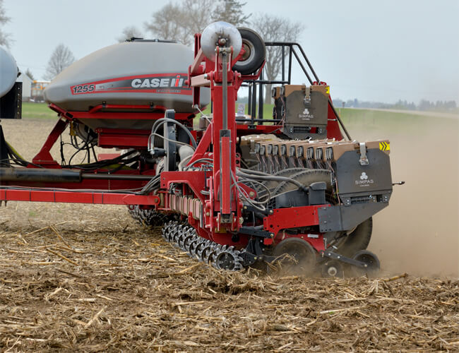 a Simpas in-furrow application attachment on a Case IH 1255 Front Fold Trailing