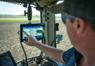 Farmer monitoring the SIMPAS equipment from his tractor