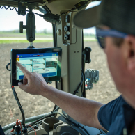 Farmer monitoring the SIMPAS equipment from his tractor