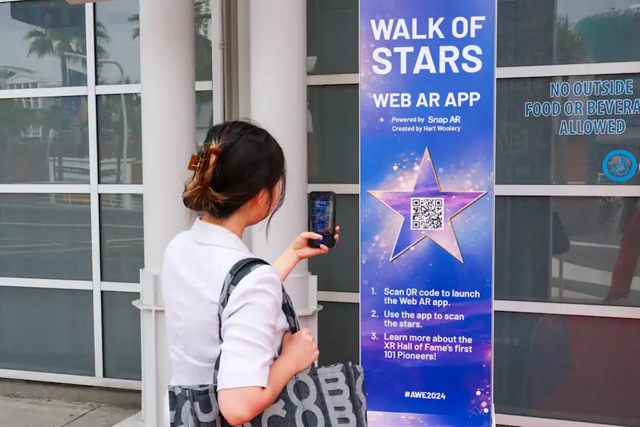 A woman uses AWE's Hall of Fame WebAR Experience while at the Augmented World Expo.