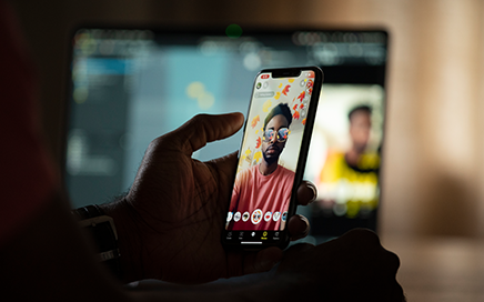 Image showing a person holding a phone with a Snapchat Lens