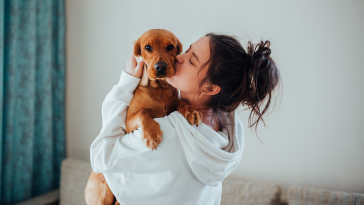 woman loving young dog