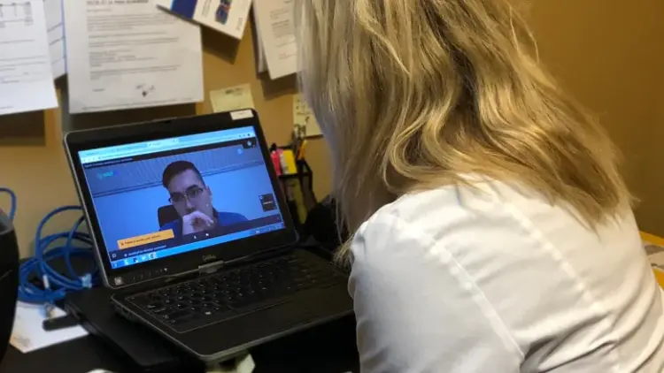 veterinarian teleconferencing with patient