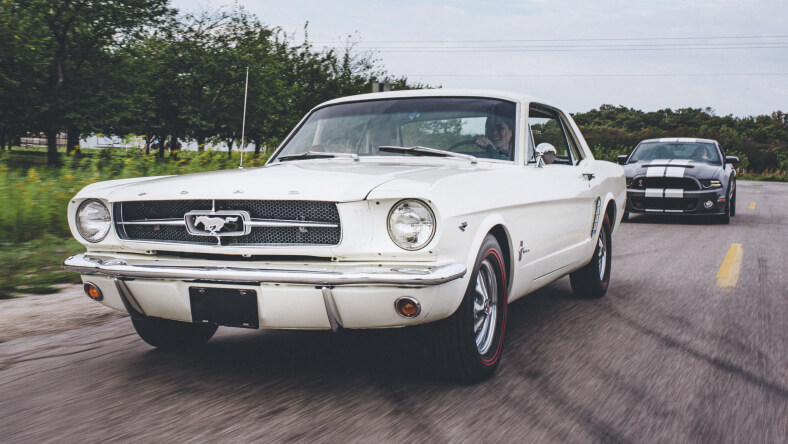 Woman driving a white Mustang