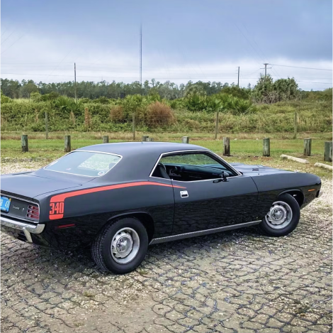 A black 1970 Plymouth Barracuda with red 'hockey stick' stripes