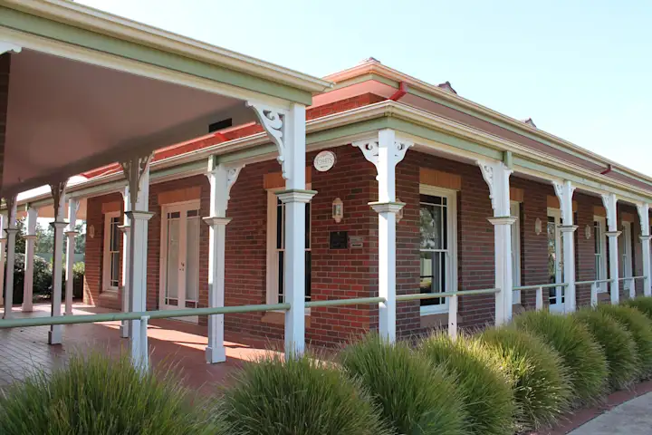 Side view of the Candlebark Function Room with white posts lining the building