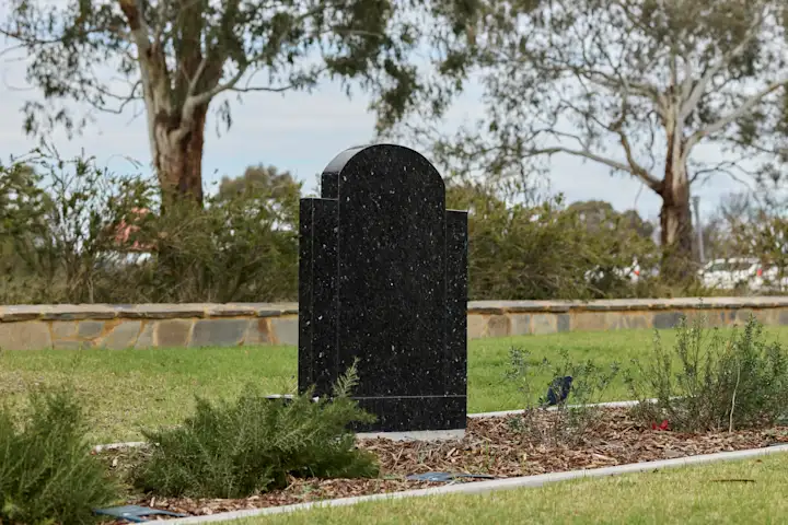 Granite Headstone in Cemetery Garden