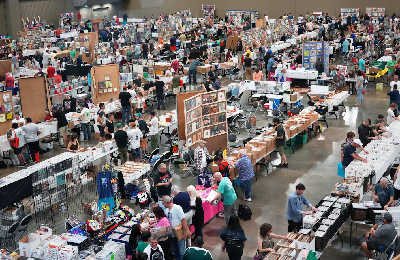 Collectors browse long rows of vinyl-filled vendor tables inside Austin’s Palmer Events Center during an Austin Record Convention