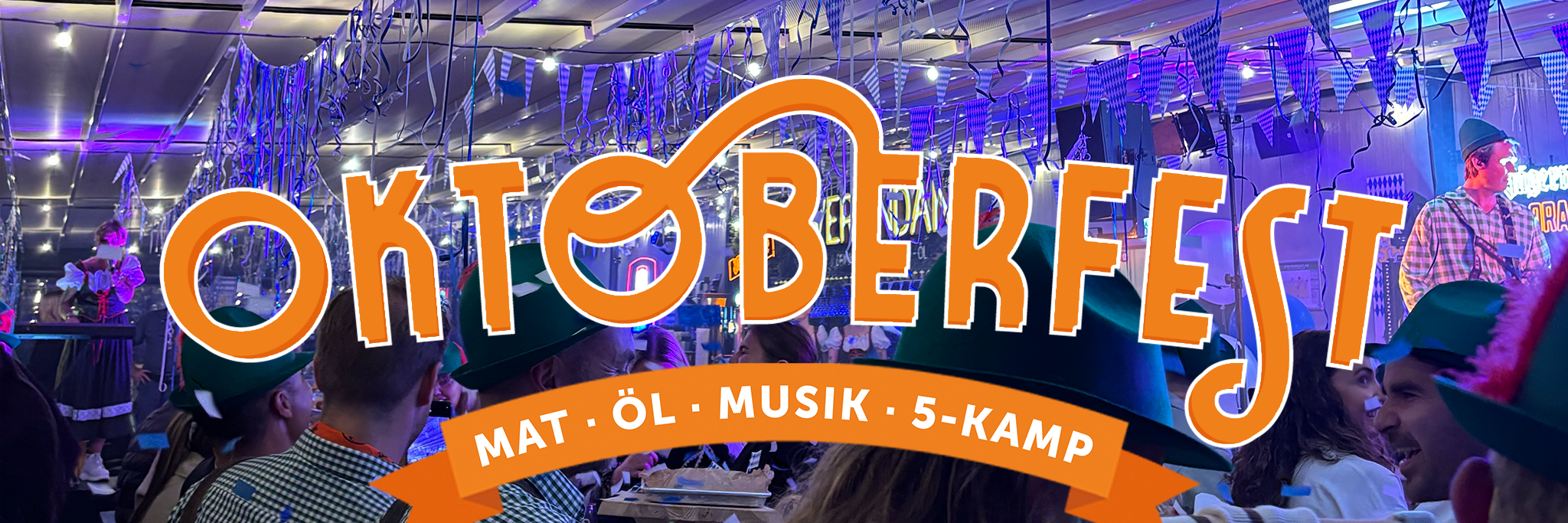 People in festive hats attend an indoor Oktoberfest event with decorations, blue lights, and a large banner reading “Oktoberfest – Mat, Öl, Musik, 5-Kamp.”.