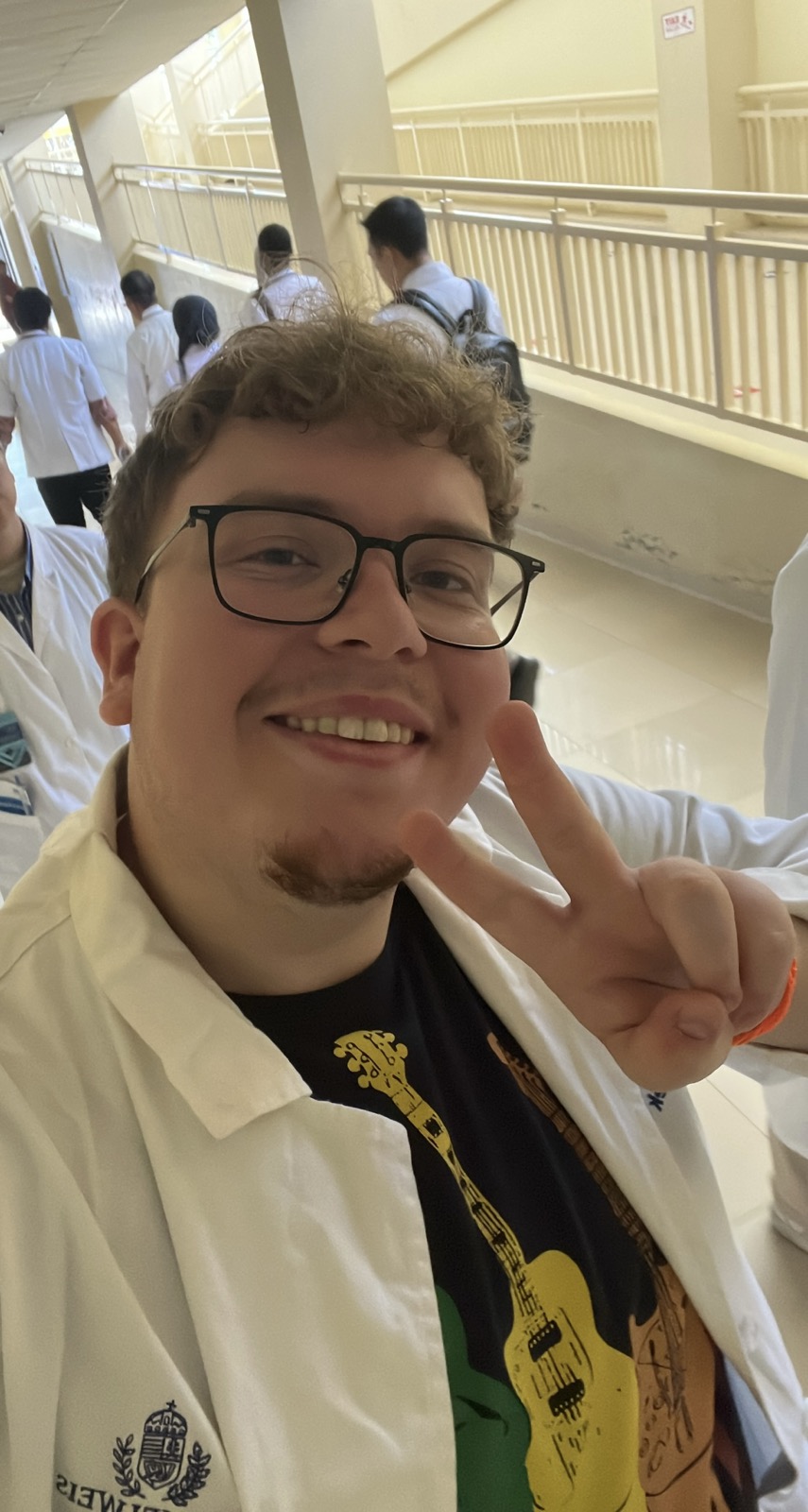 A selfie of Benő⁩, smiling and offering a peace sign with one hand