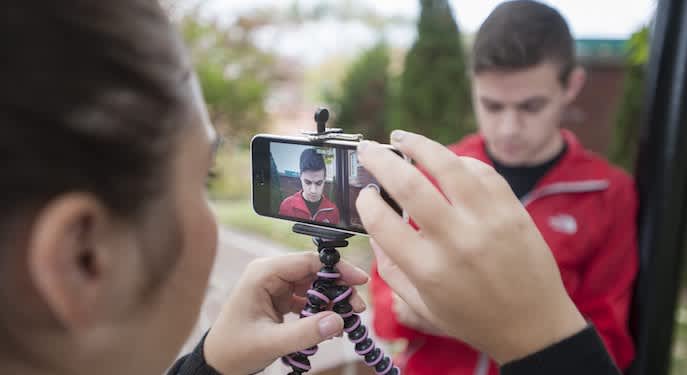 Picture of a student taking video using a phone